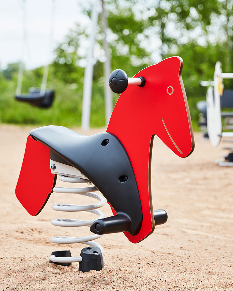 Springer toy for outdoor playgrounds shaped like a horse, in red.